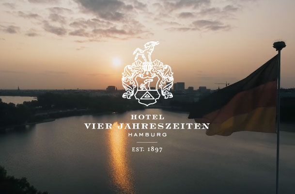 Sunset over Hamburg and the Hotel Vier Jahreszeiten logo